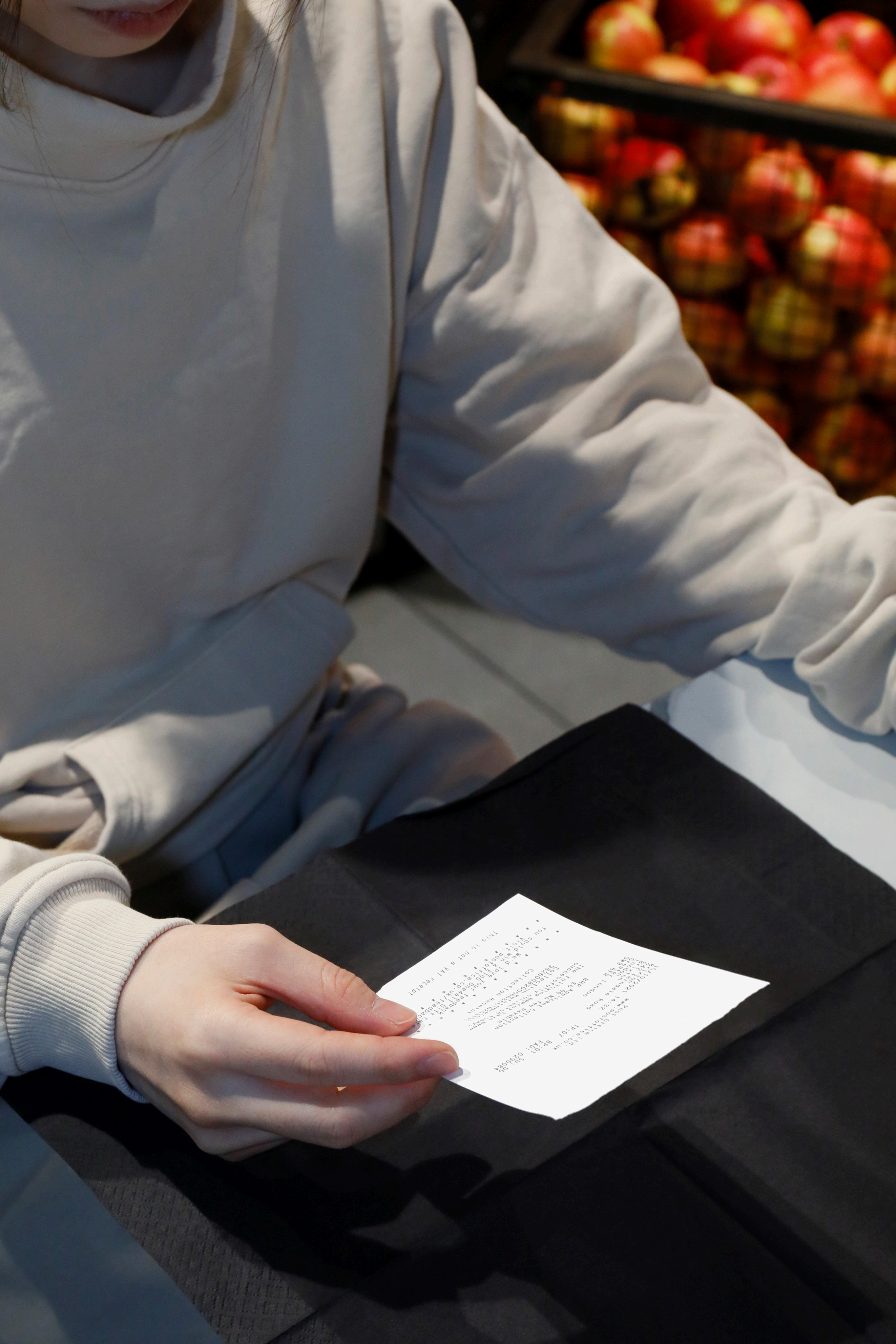 A resident holding a personal receipt